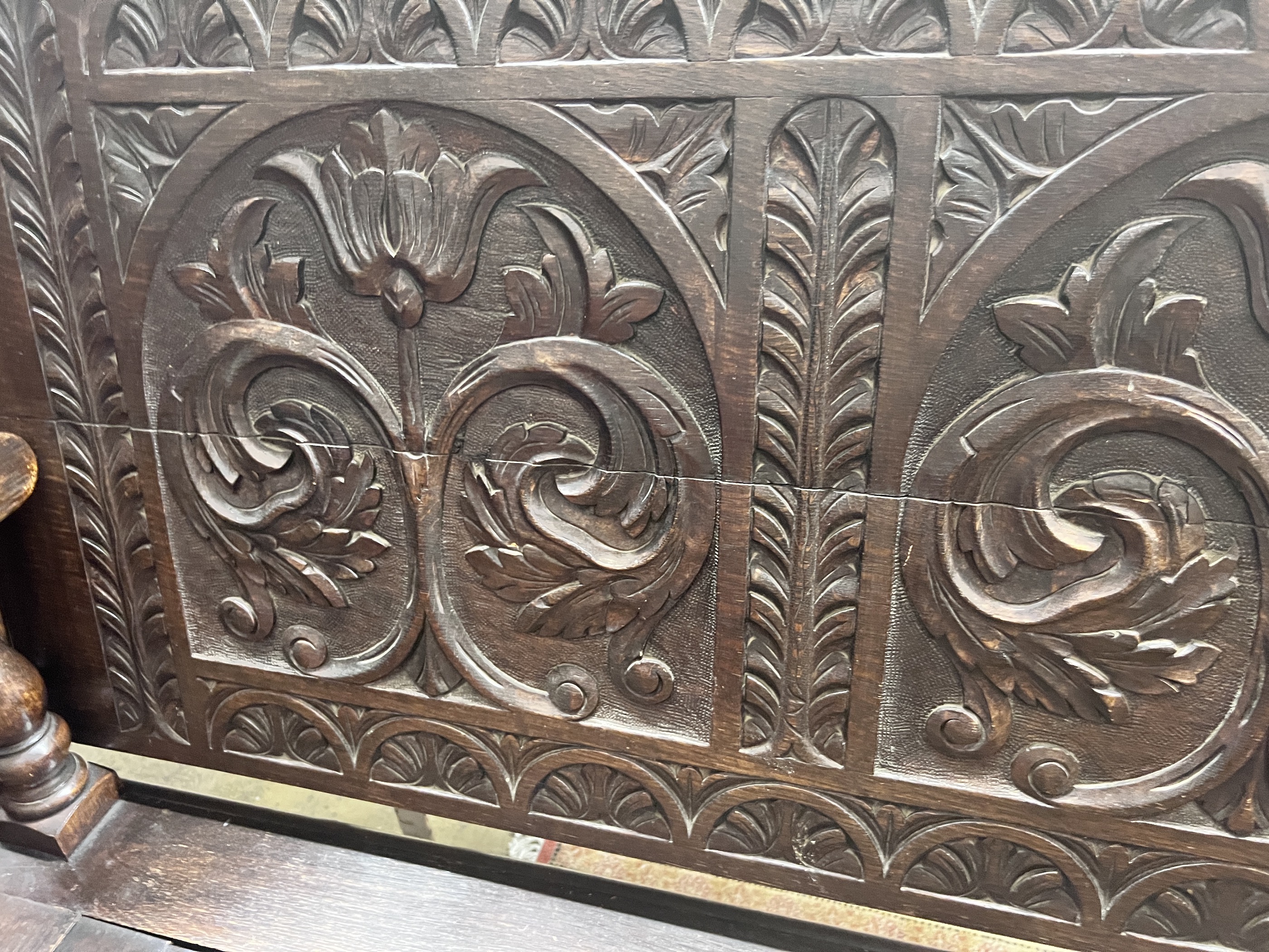 A 1920’s carved oak monk's bench, width 122cm, depth 51cm, height 78cm